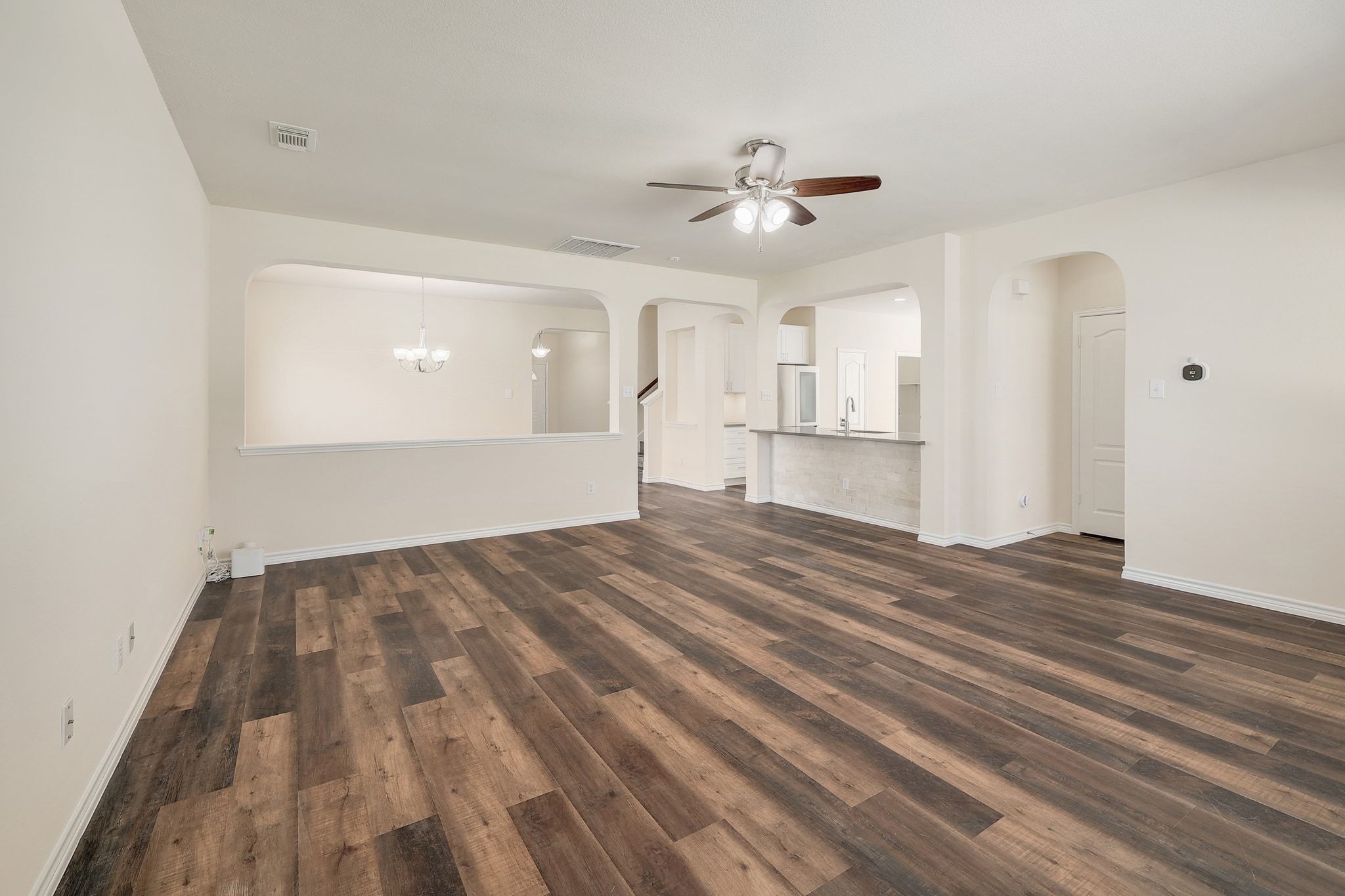 2307 Hayfield Square Pflugerville, TX 78660 - Photo 7 of 40 a view of empty room with wooden floor and ceiling fan
