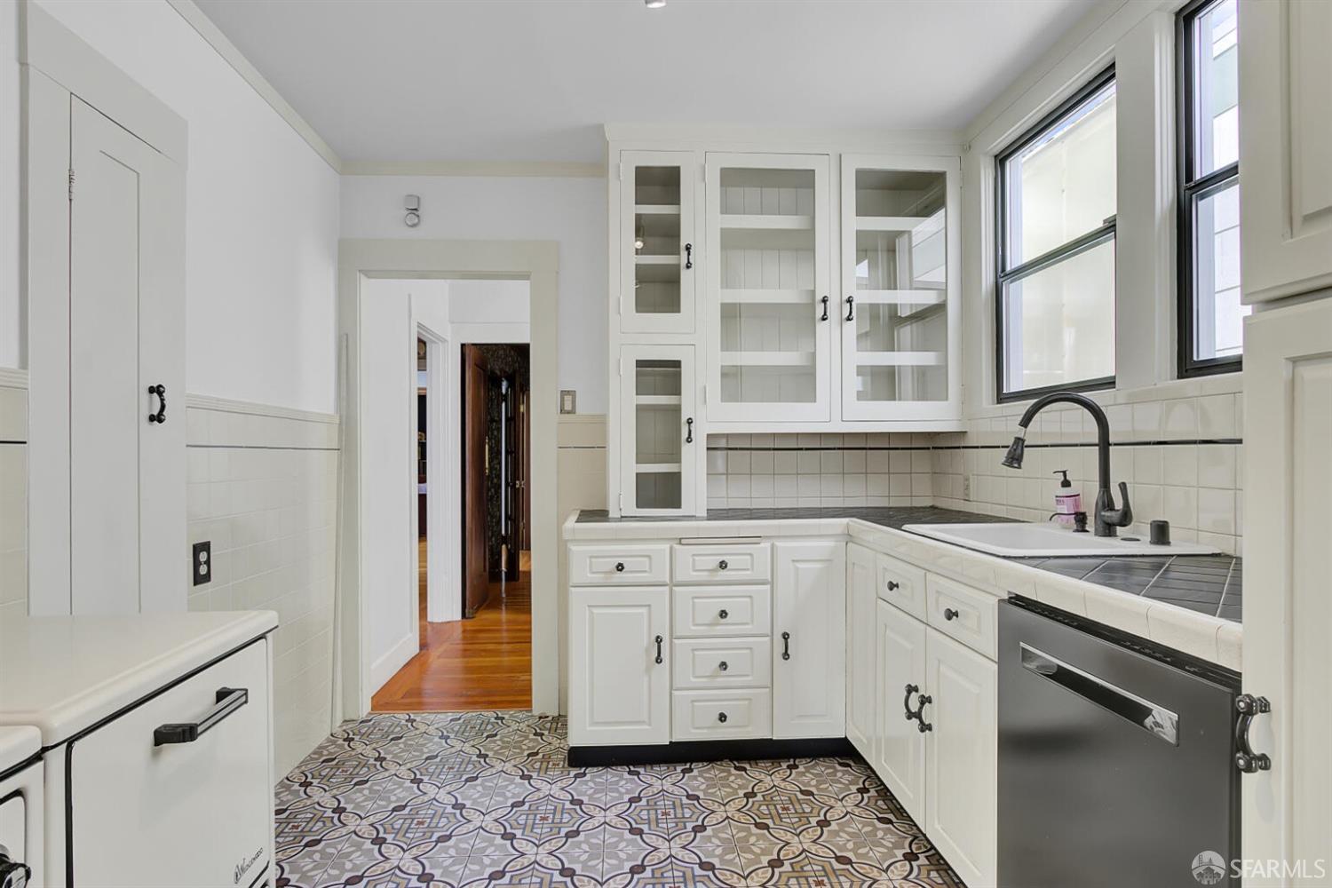 3927 Clement Street San Francisco, CA 94121 - Photo 28 of 72 a kitchen with a sink stove and refrigerator