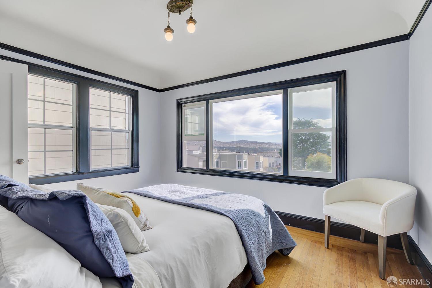 3927 Clement Street San Francisco, CA 94121 - Photo 29 of 72 a spacious bedroom with a bed and a large window