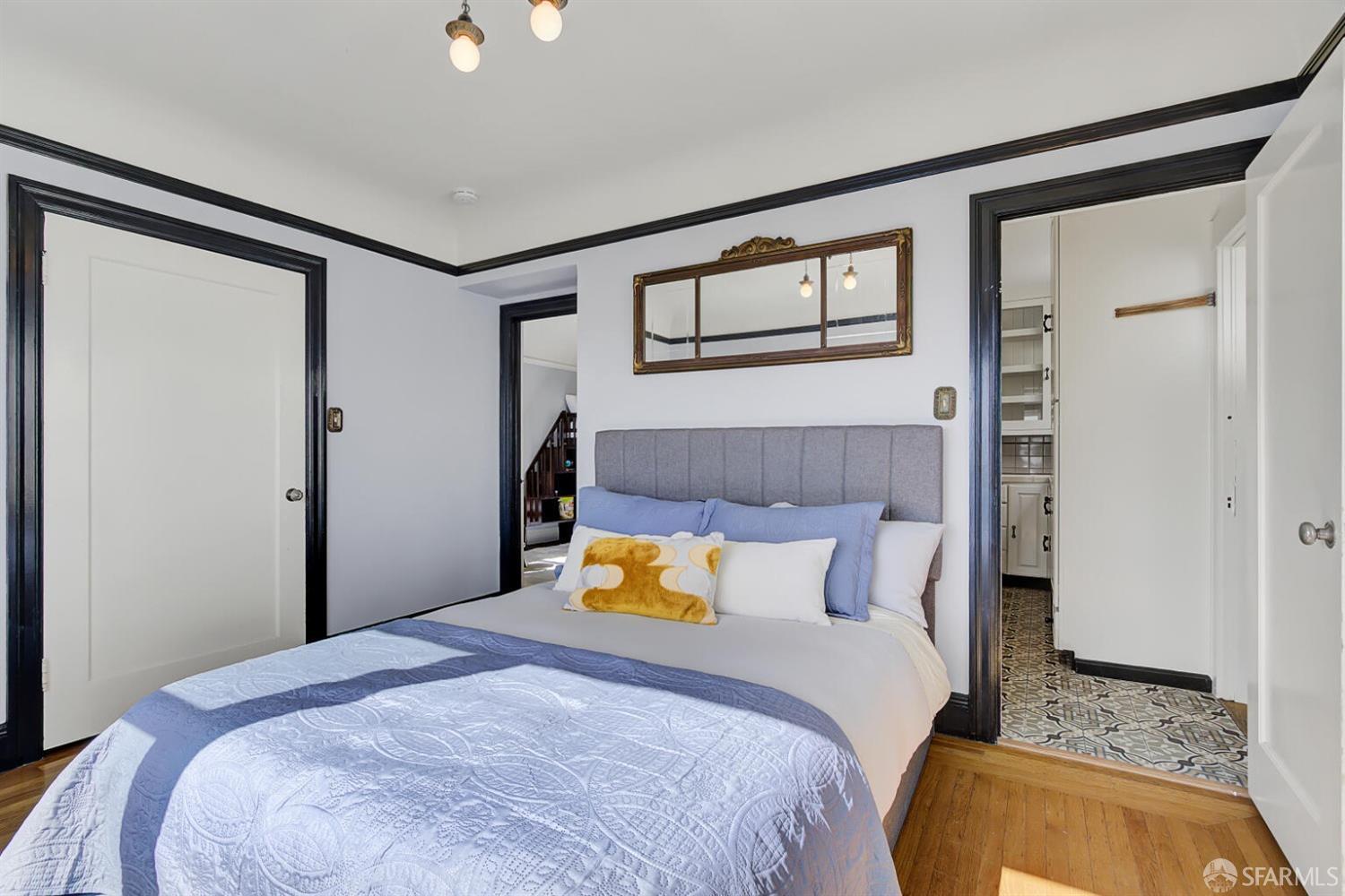 3927 Clement Street San Francisco, CA 94121 - Photo 32 of 72 a bedroom with a bed and wooden floor