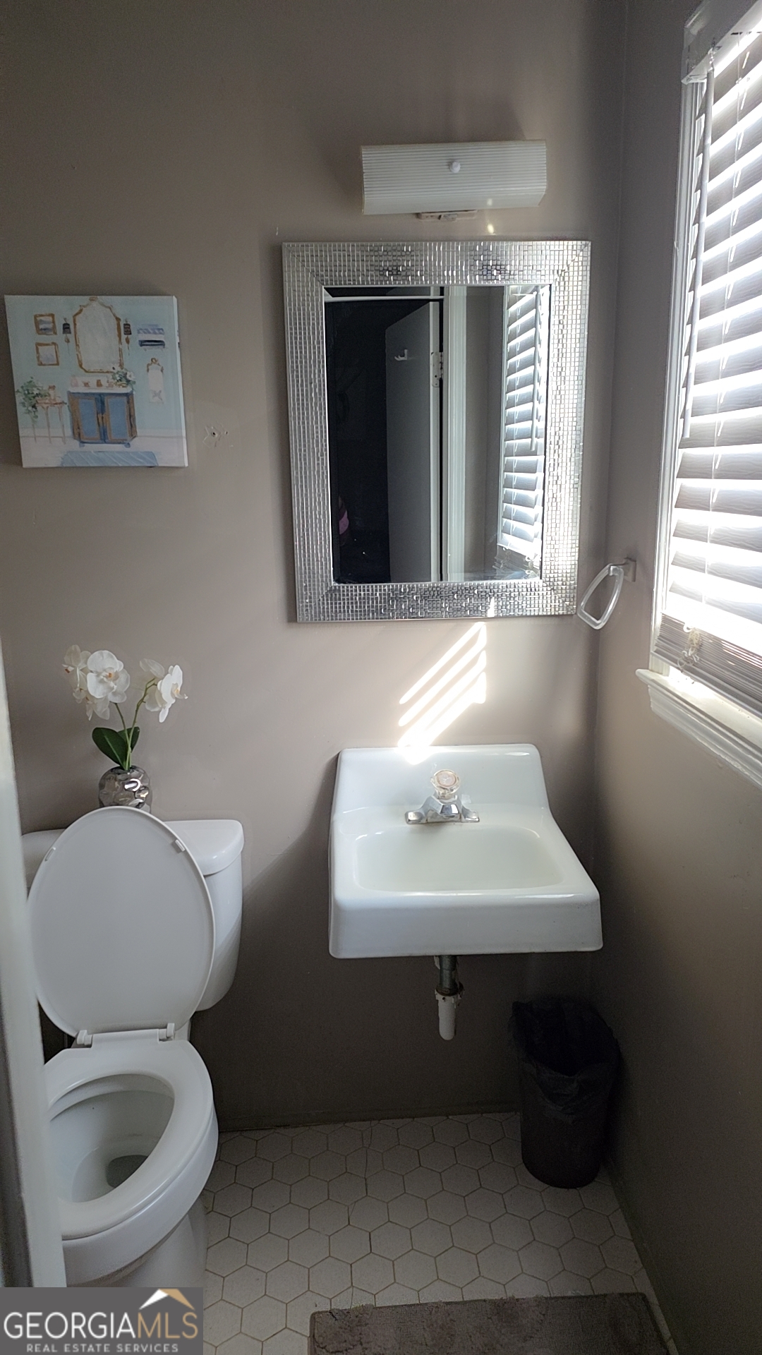 293 Williams Street Northeast Pelham, GA 31779 - Photo 11 of 19 a bathroom with a toilet sink and mirror