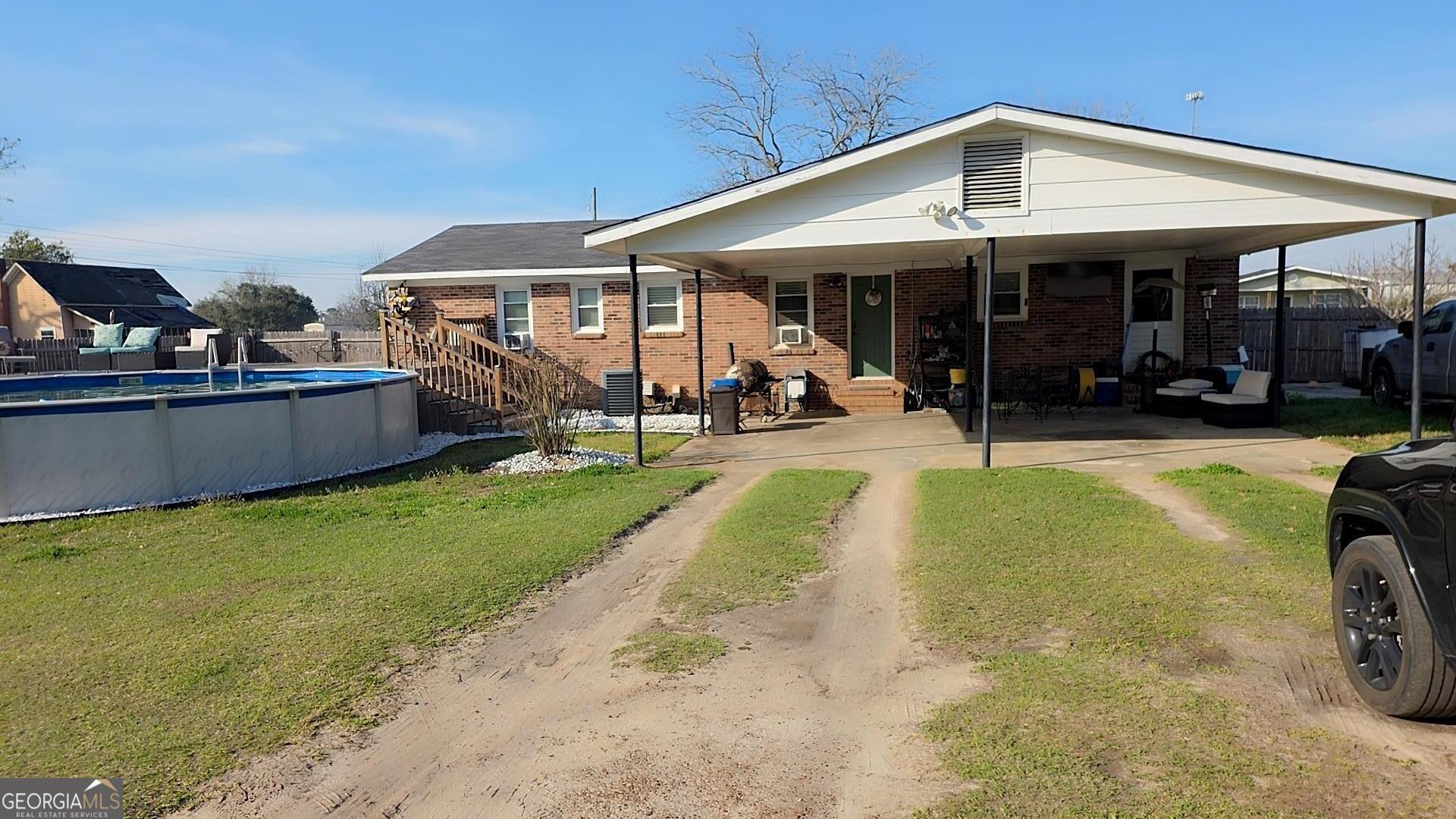 293 Williams Street Northeast Pelham, GA 31779 - Photo 15 of 19 a view of a house with a yard patio and swimming pool