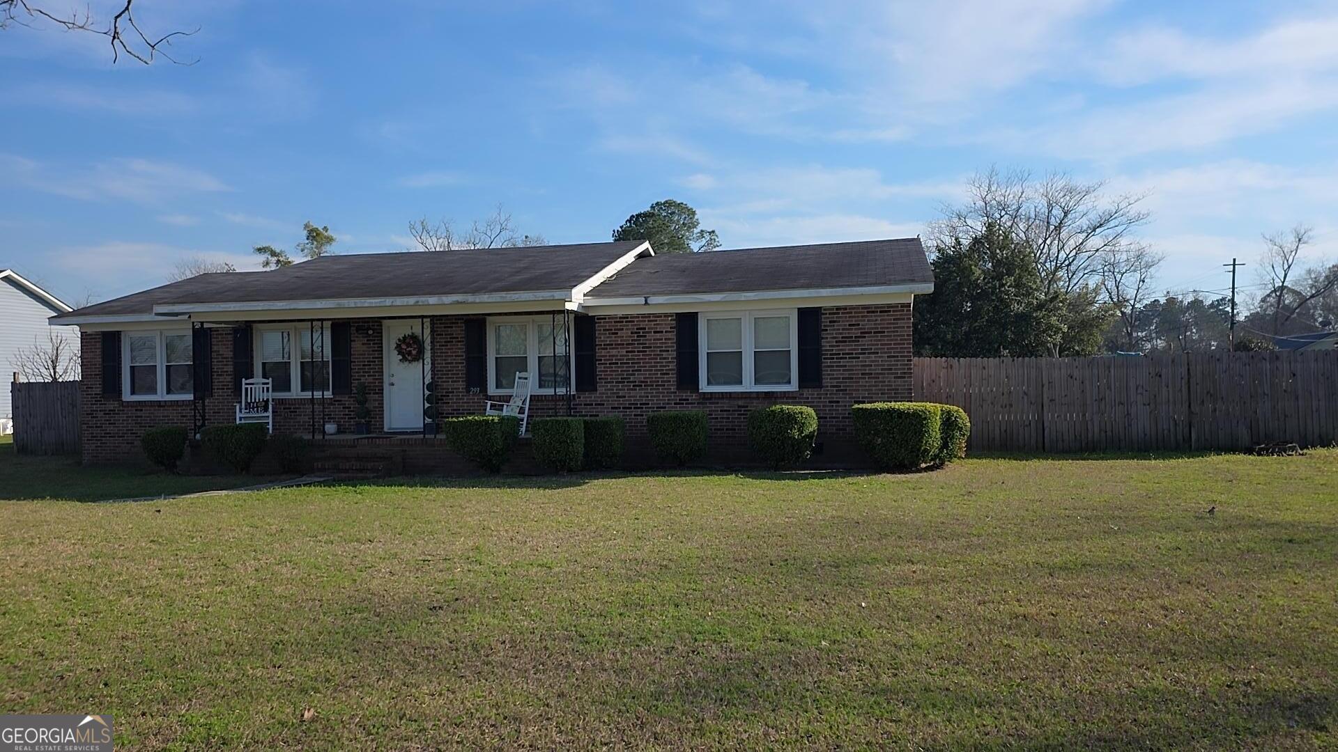293 Williams Street Northeast Pelham, GA 31779 - Photo 19 of 19 a front view of a house with a garden and yard