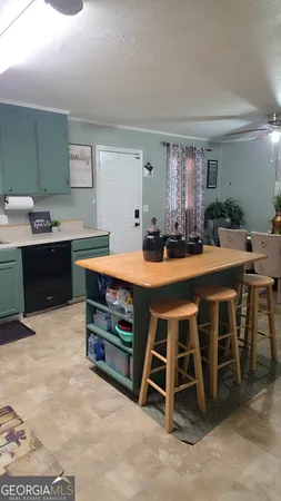 a table and chairs in a room with kitchen view