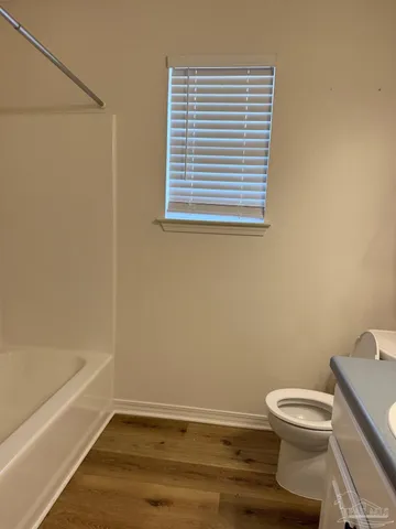 a bathroom with a toilet and a bathtub