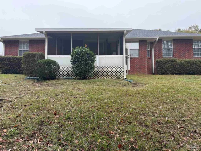 a view of a house with a yard and garage