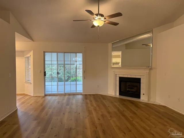 wooden floor fireplace and natural light in room