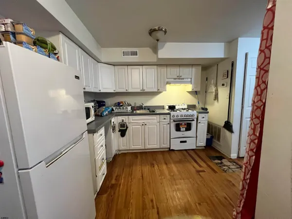 a kitchen with stove a refrigerator and a stove