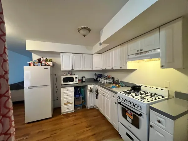 a kitchen with a stove a refrigerator and a stove