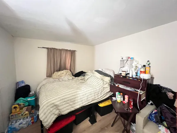 a bedroom with a bed and painting on the wall