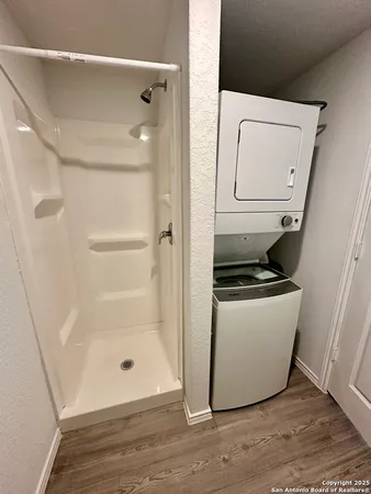 a room with wooden floor and white cabinet