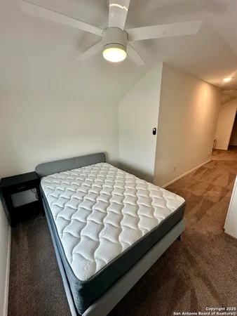 a bed sitting in a bedroom next to a window