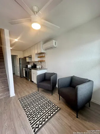 a living room with furniture and a rug