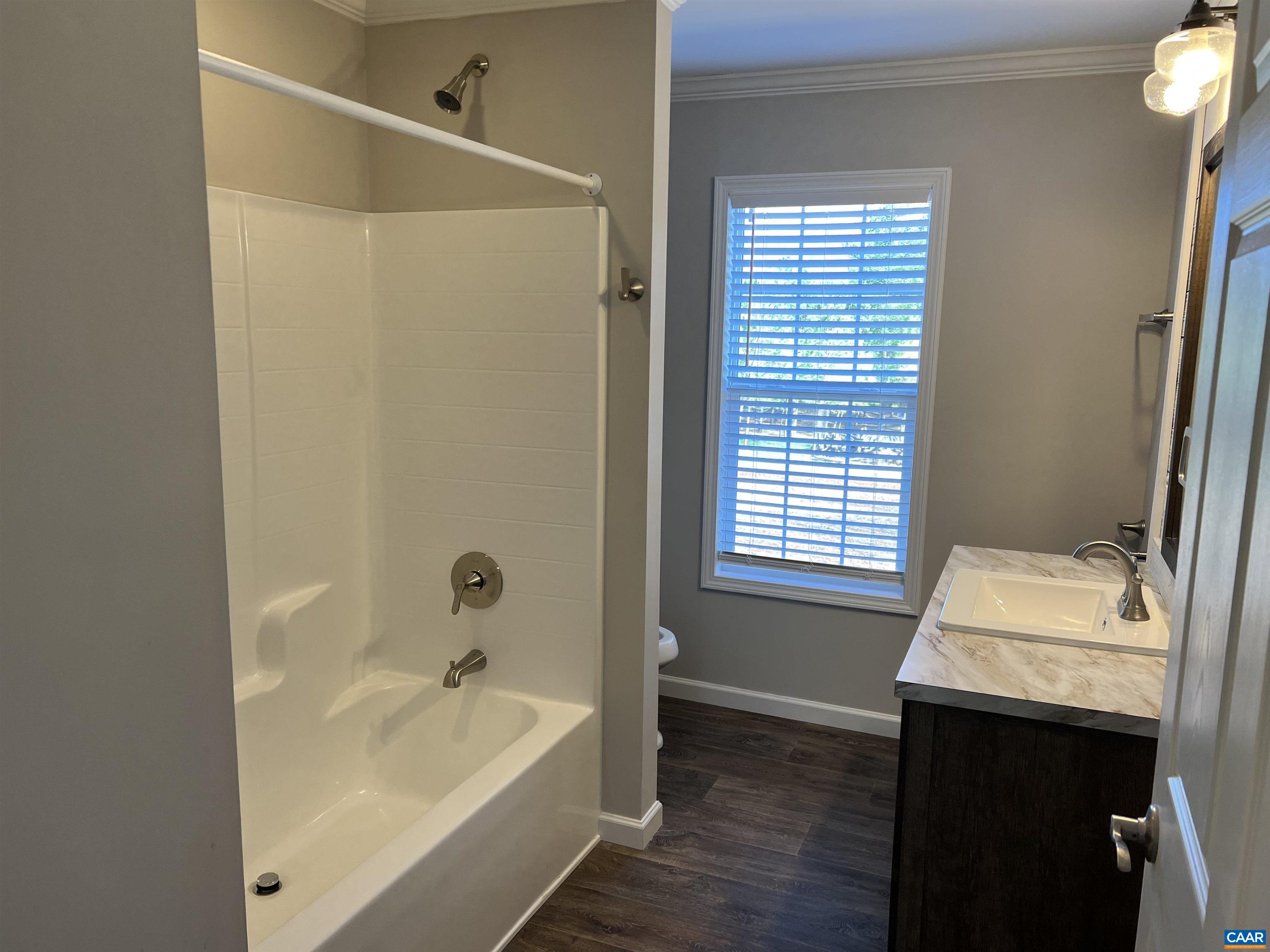 3123 Scottsville Road Charlottesville, VA 22902 - Photo 14 of 22 a bathroom with a sink and a bathtub