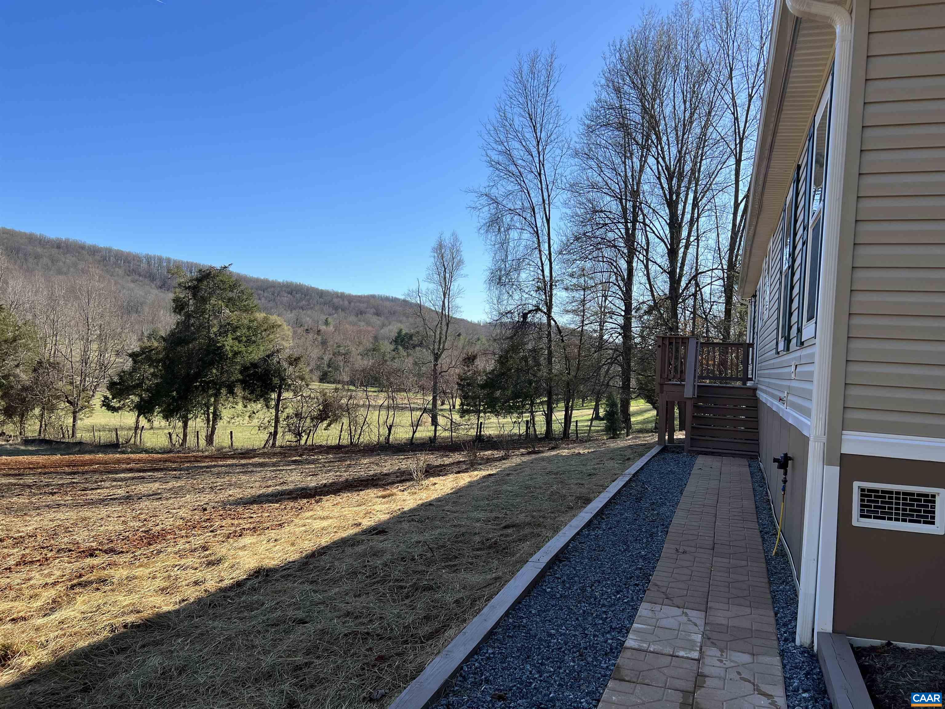 3123 Scottsville Road Charlottesville, VA 22902 - Photo 20 of 22 a street view with wooden fence and mountain view