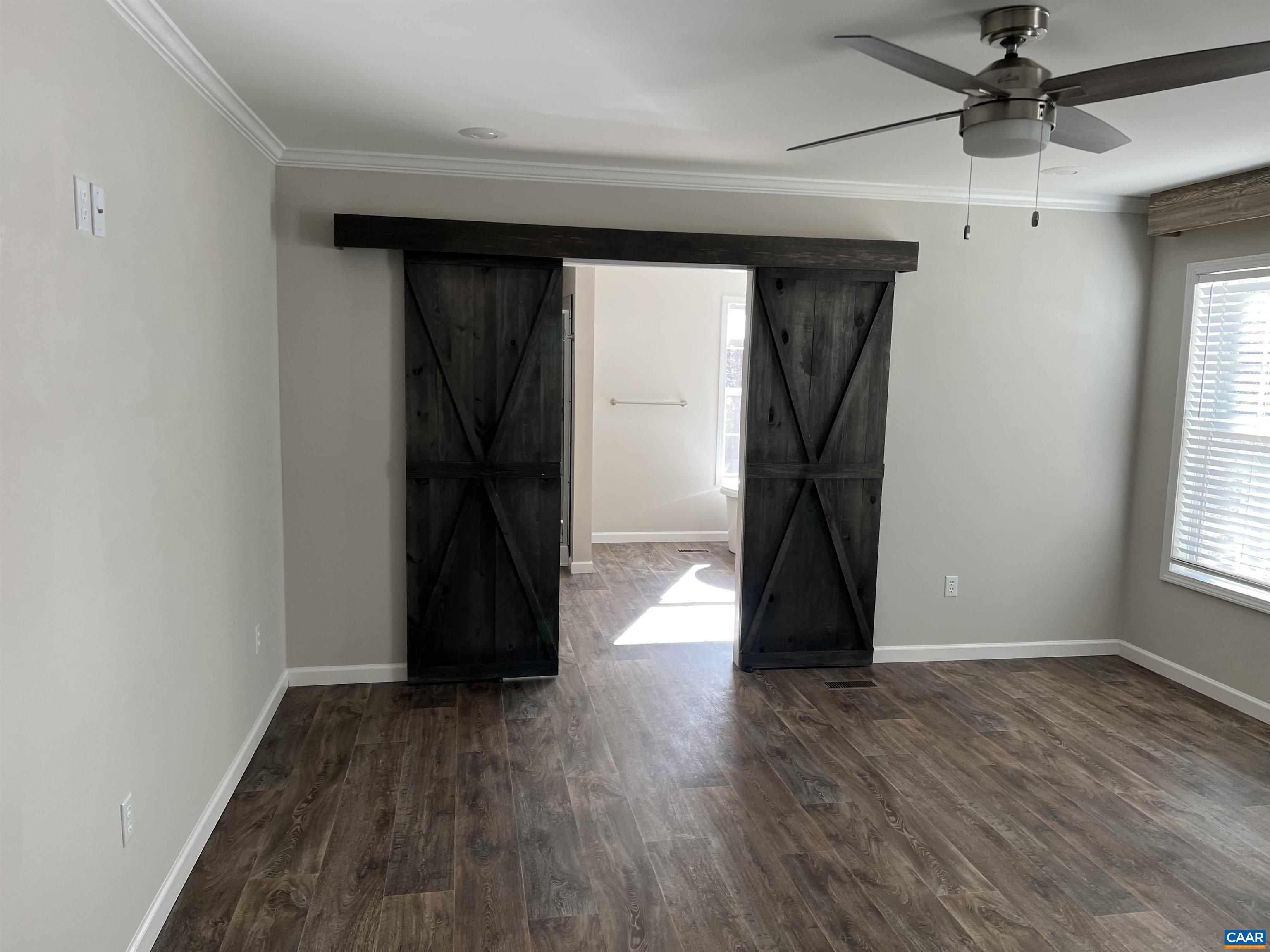 3123 Scottsville Road Charlottesville, VA 22902 - Photo 8 of 22 a view of empty room with wooden floor and fan