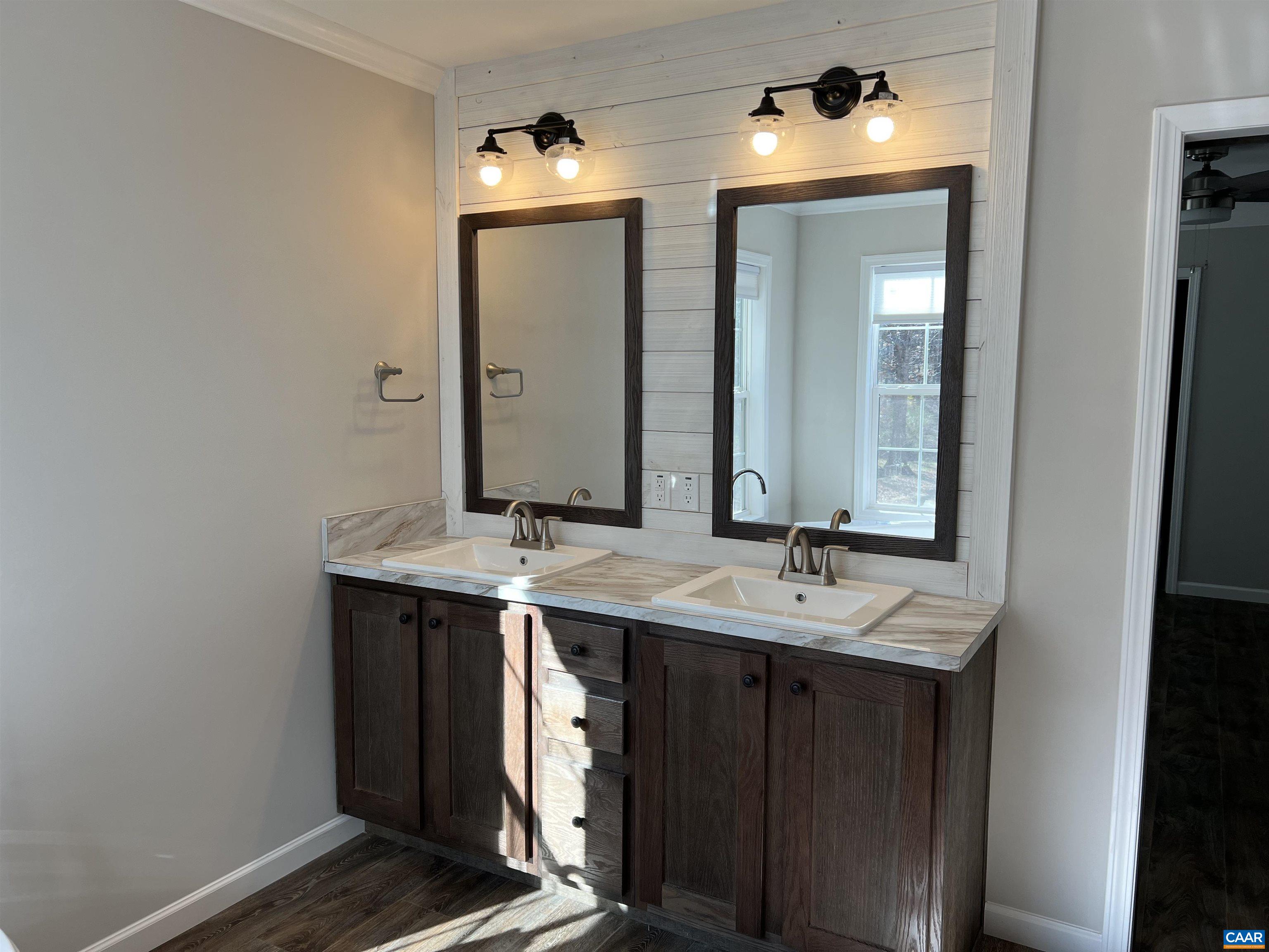3123 Scottsville Road Charlottesville, VA 22902 - Photo 9 of 22 a bathroom with a double vanity sink and a mirror