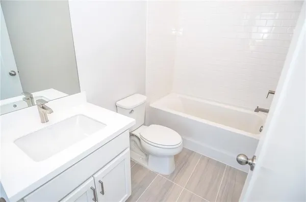 a bathroom with a toilet and a bathtub