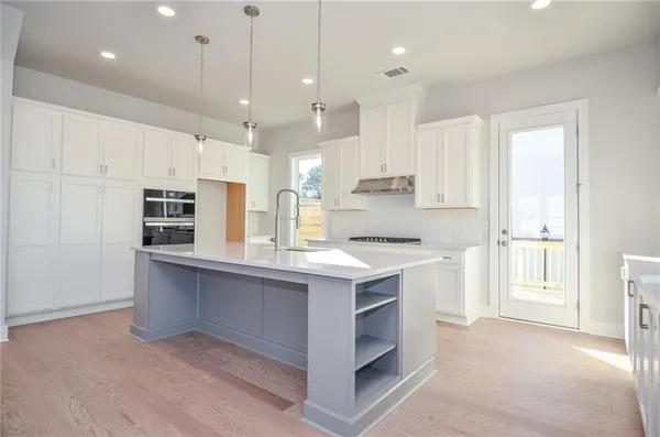 a kitchen with a sink window and cabinets
