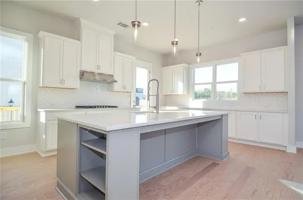 a kitchen with stainless steel appliances a sink stove and refrigerator