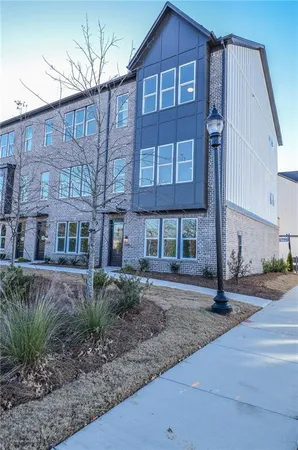 a view of a brick building next to a yard
