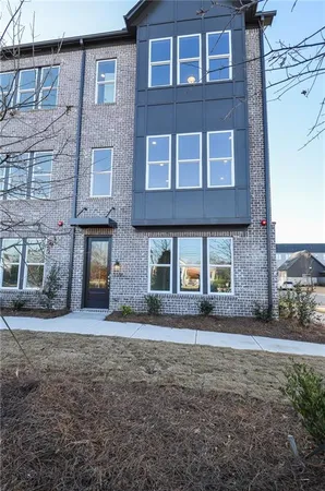 a front view of a building with a yard