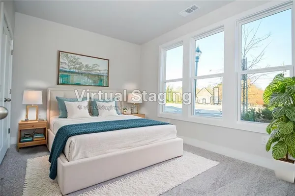 a spacious bedroom with a bed and a window