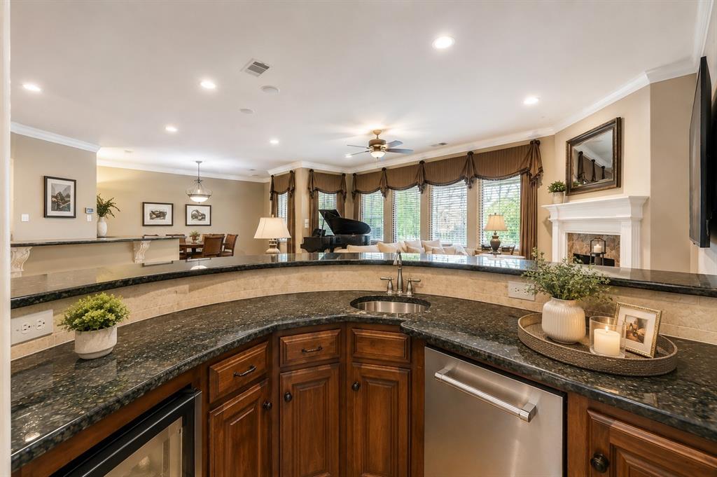 2726 Country Club Road Pantego, TX 76013 - Photo 11 of 23 a kitchen with granite countertop a sink and a white wooden cabinets