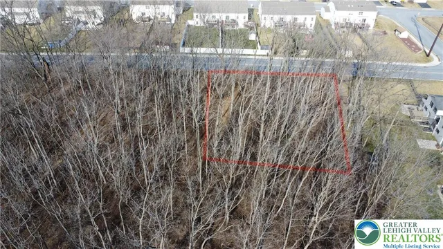 a view of backyard with wooden fence