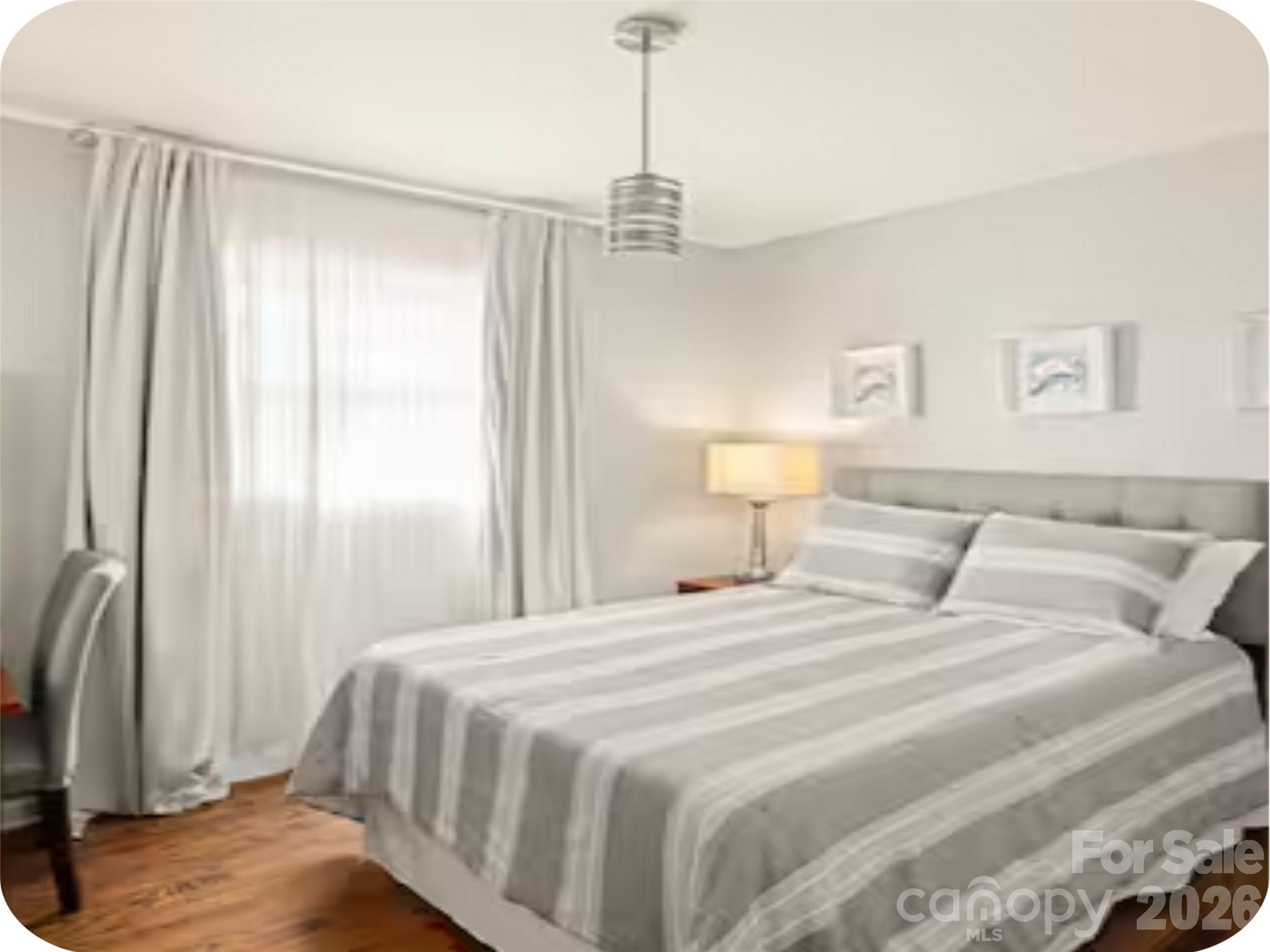 502 Long Shoals Road Arden, NC 28704 - Photo 16 of 32 a bedroom with a bed a window and a chandelier