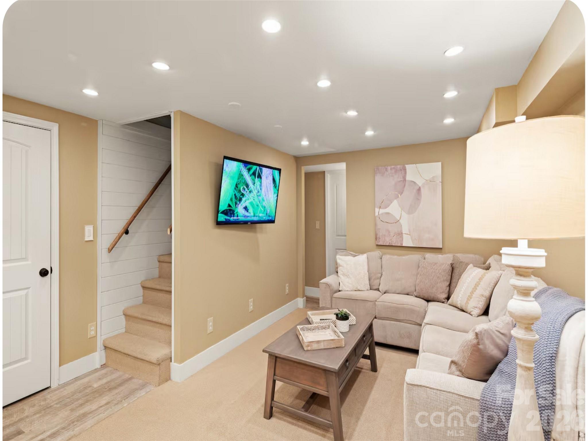 502 Long Shoals Road Arden, NC 28704 - Photo 17 of 32 a living room with furniture and a flat screen tv