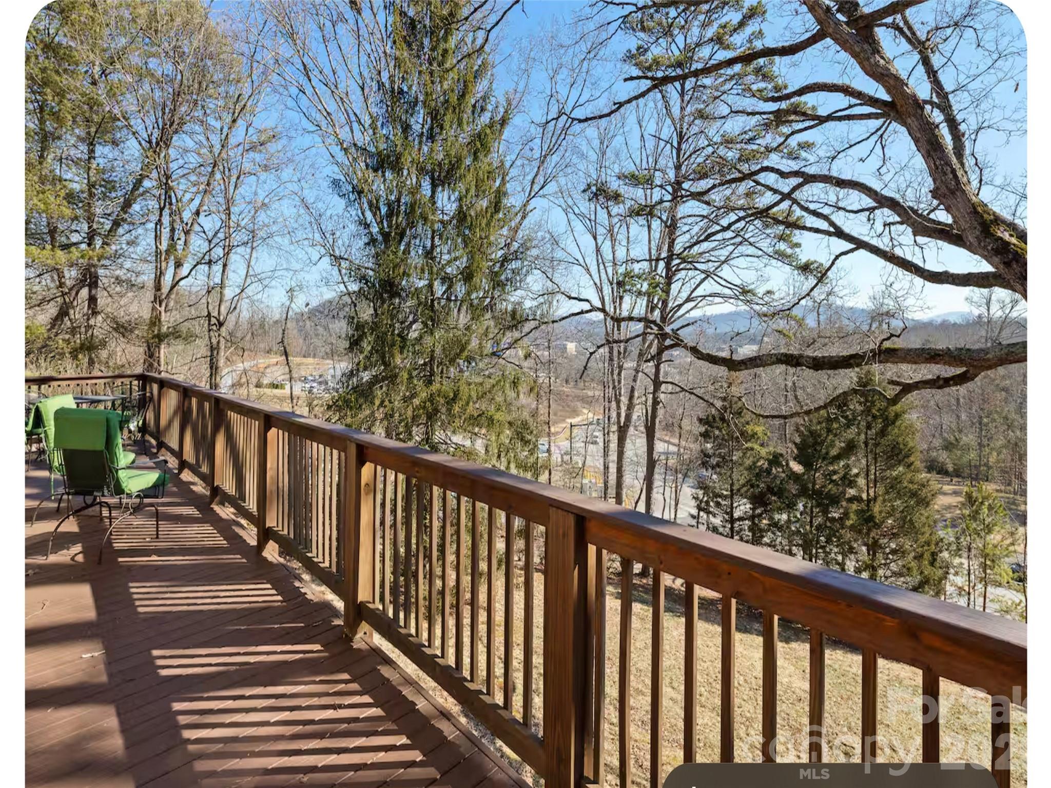 502 Long Shoals Road Arden, NC 28704 - Photo 19 of 32 a view of a balcony with wooden fence and floor