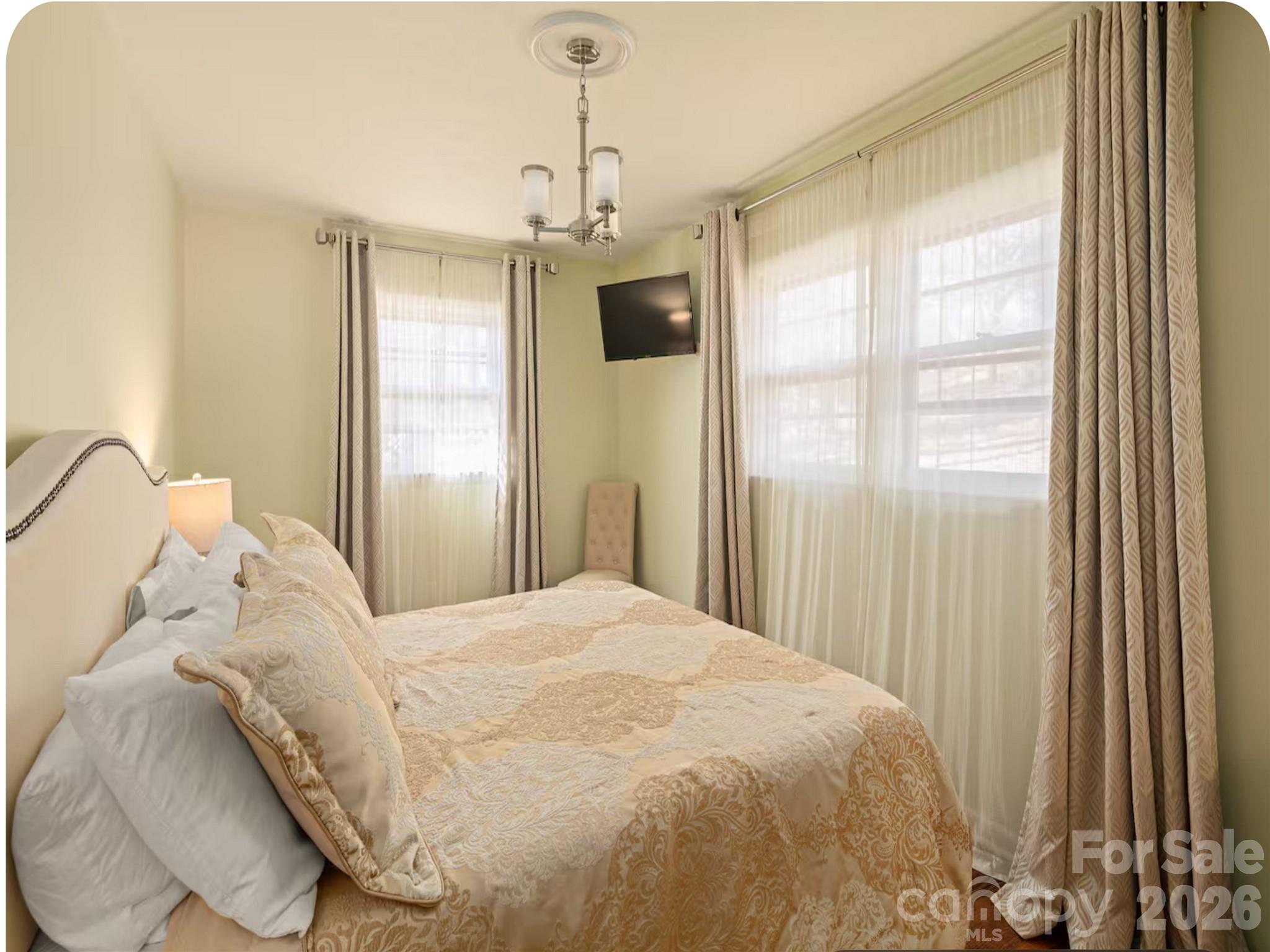 502 Long Shoals Road Arden, NC 28704 - Photo 10 of 32 a large bed sitting in a bedroom next to a window