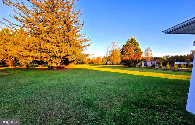 a view of outdoor space with deck and yard