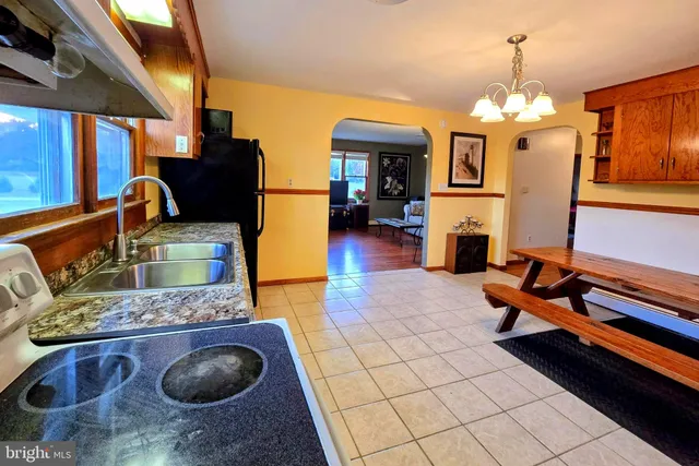 a living room with fireplace furniture and a chandelier