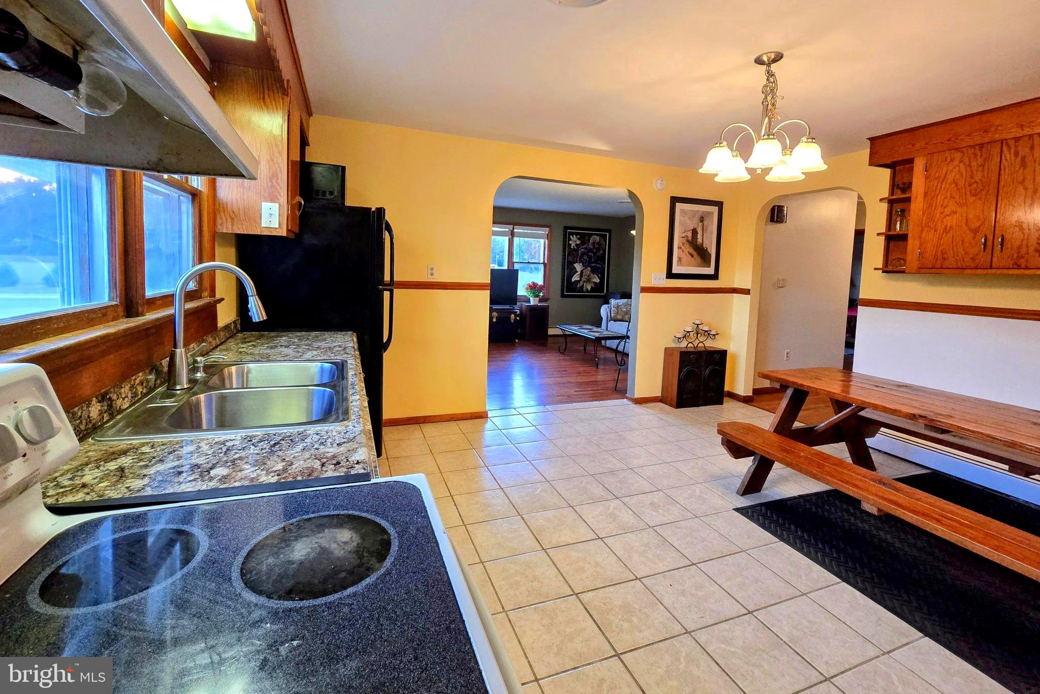 8445 North Old State Road Lincoln, DE 19960 - Photo 6 of 32 a living room with fireplace furniture and a chandelier