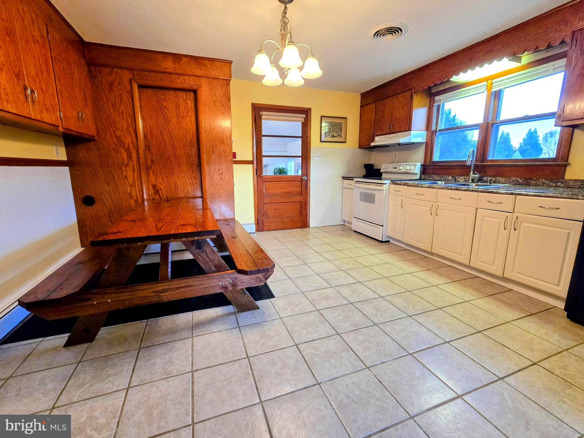 8445 North Old State Road Lincoln, DE 19960 - Photo 9 of 32 a kitchen with stainless steel appliances granite countertop a stove a sink and a microwave