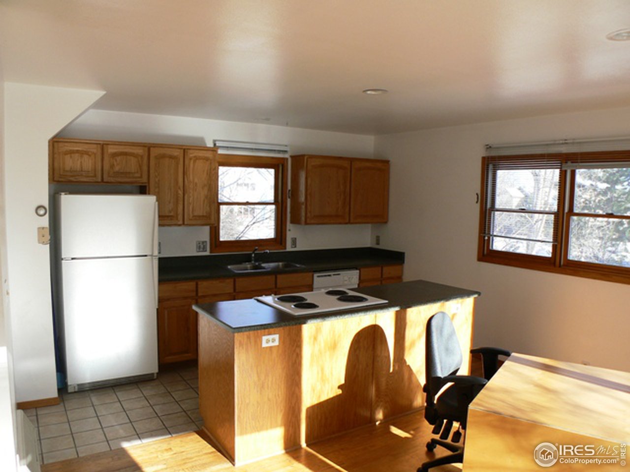 4160 Riverside Avenue Boulder, CO 80304 - Photo 8 of 17 a kitchen with a refrigerator a stove a microwave and a window