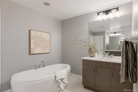 a bathroom with a double vanity sink mirror and shower