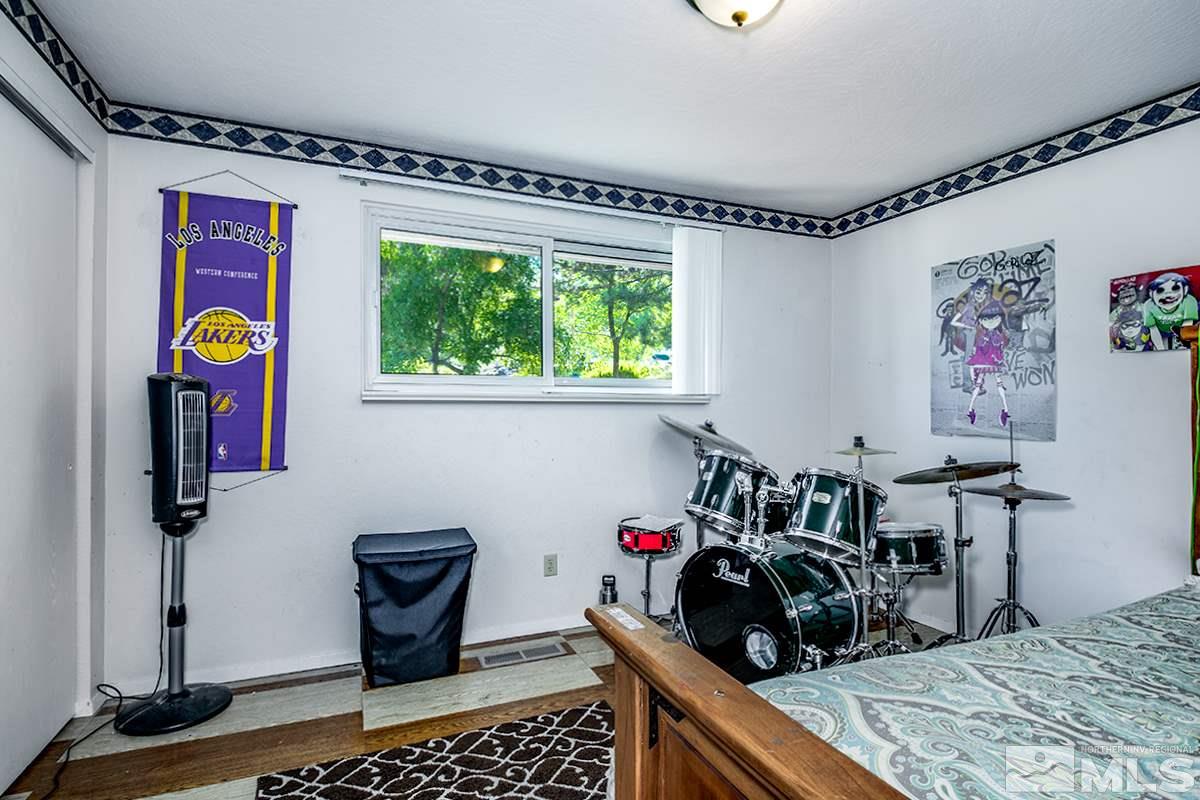 13805 Virginia Foothills Drive Reno, NV 89521 - Photo 16 of 25 a bedroom with a bed and a window