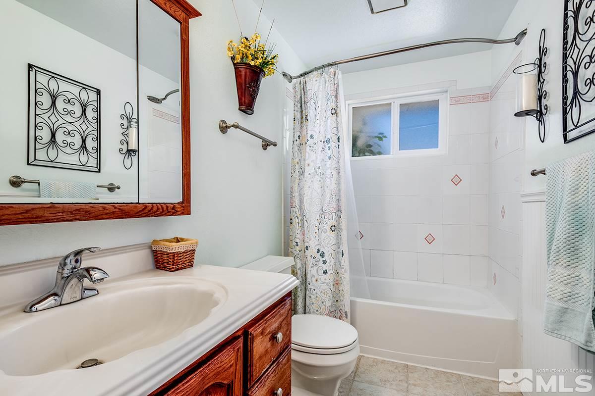 13805 Virginia Foothills Drive Reno, NV 89521 - Photo 17 of 25 a bathroom with a sink a toilet and a bathtub