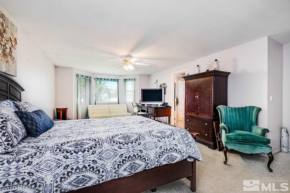 13805 Virginia Foothills Drive Reno, NV 89521 - Photo 19 of 25 a bedroom with a bed a couch and dresser