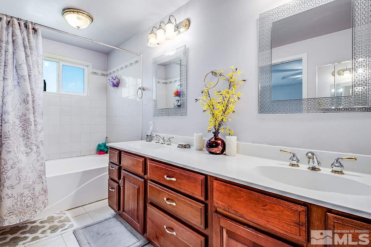 13805 Virginia Foothills Drive Reno, NV 89521 - Photo 21 of 25 a bathroom with a tub sink and mirror