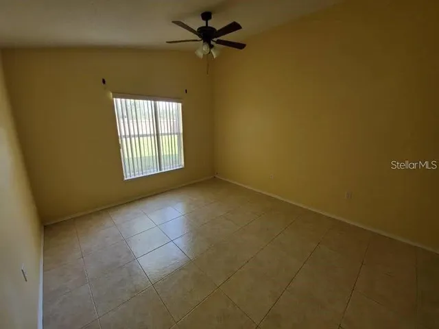 a view of a livingroom with a ceiling fan and window