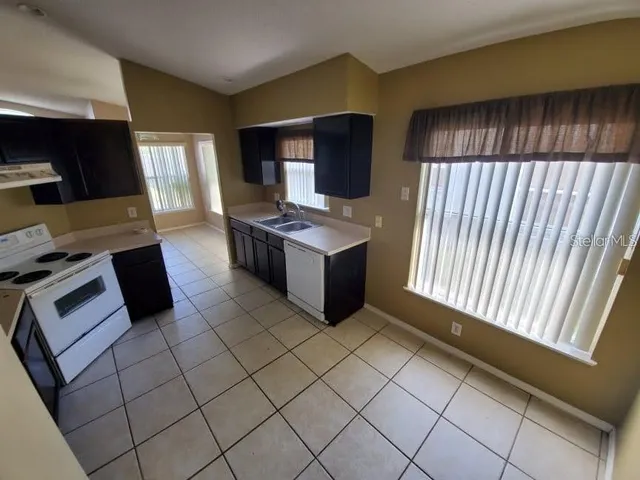 a kitchen with a stove and a refrigerator