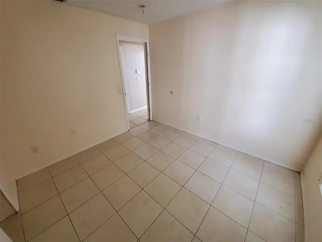 a view of an empty room and wooden floor