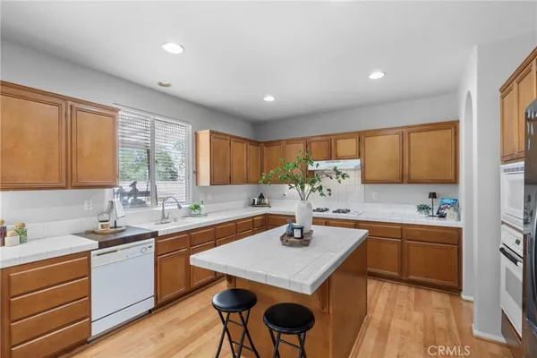 a kitchen with a sink window and cabinets