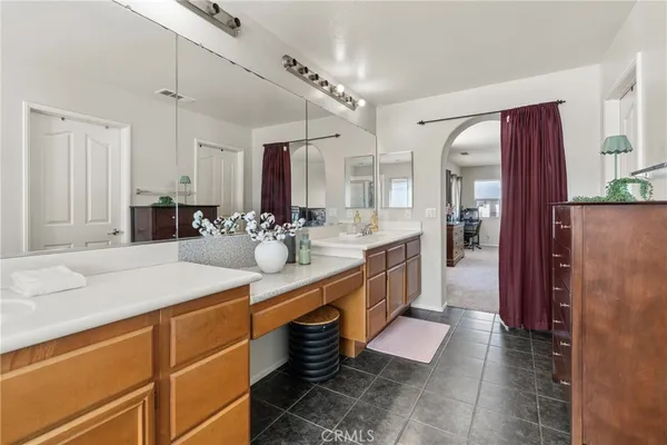 a kitchen with stainless steel appliances kitchen island granite countertop a refrigerator and a sink