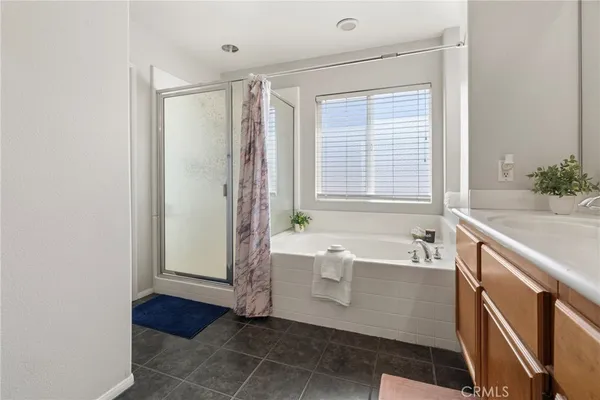 a bathroom with a bathtub a sink and a shower