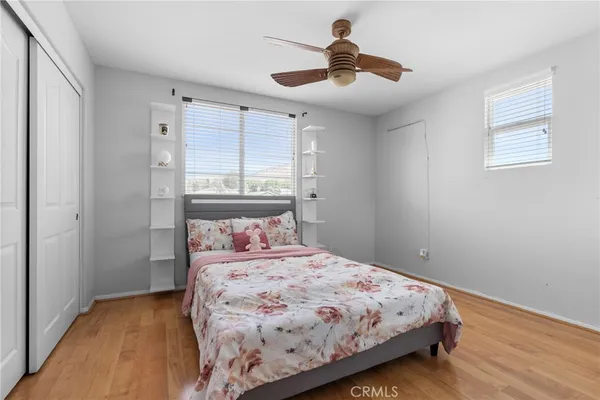 a bedroom with a large bed and a chandelier